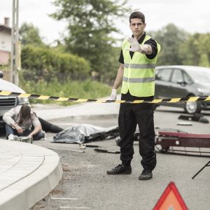 Policeman at road accident scene