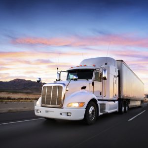 Truck and highway at sunset