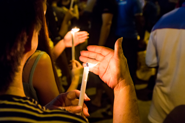Group of people holding candle vigil
