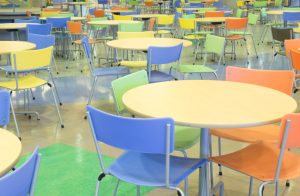 Tables in a big colorful school cafeteria