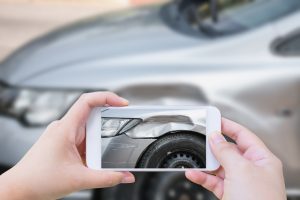 using smartphone take photo car crash accident of the damage to the car for accident insurance