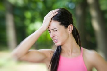 Woman in pain holding her head