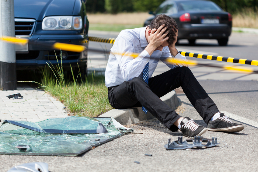 Sad man at accident scene