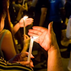 Group of people holding candle vigil