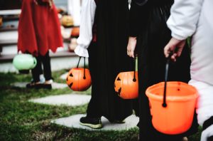 Little children in Halloween costumes trick or treating