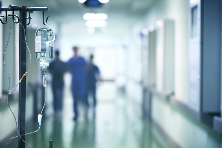 Group of doctors in a hurry down the hospital hallway for emergency