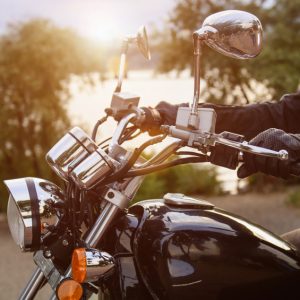 Biker riding on motorcycle near the river in the city.