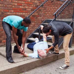 Men helping man who fell down the stairs