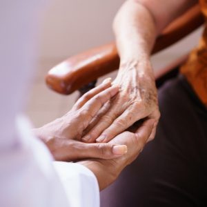 senior woman in nursing home clasped hand