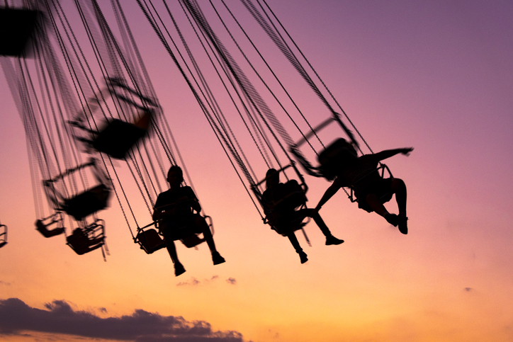 People riding on a swing ride at the amusement park