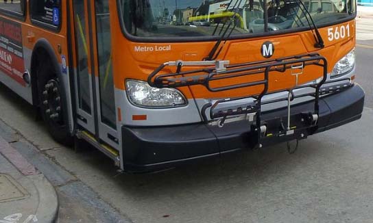 image of the front of an orange city bus. 