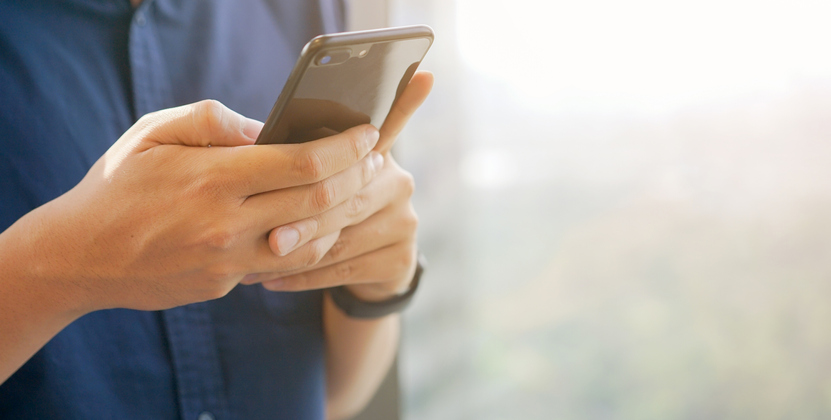 Man texting on cell phone.