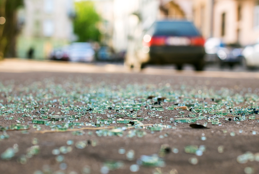 Shards of car glass on the street after a car accident.