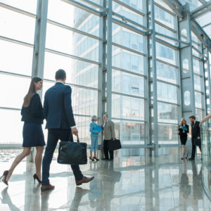 Business people walking in modern glass office building