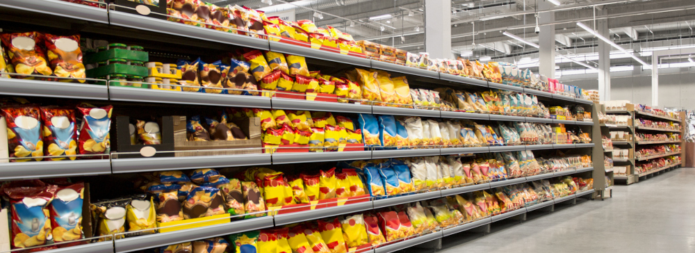 A supermarket aisle with shelves containing snacks