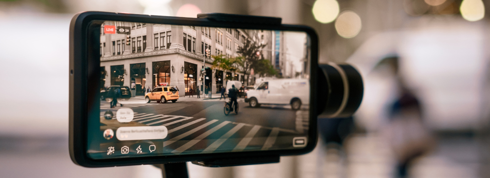 A person recording a cellphone video downtown in the city